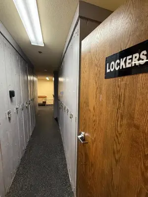 a row of lockers in a hallway with a sign on the door at The Meadows- Charmed Ski & Relax Studio in Kirkwood