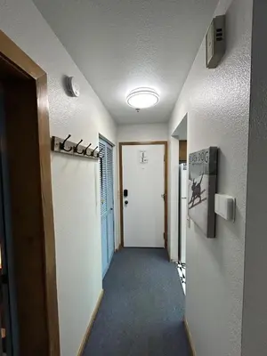 a hallway with a door leading to a room at The Meadows- Charming 1BD2BA Ski Condo in Kirkwood