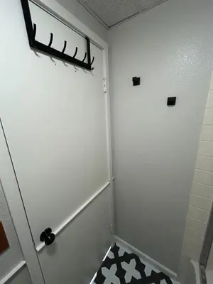 a bathroom with a white door and a black and white floor at The Meadows- Charming 1BD2BA Ski Condo in Kirkwood