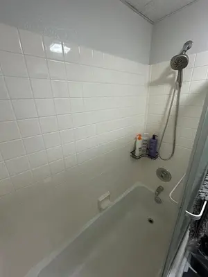 a white bathroom with a tub and a shower at The Meadows- Charming 1BD2BA Ski Condo in Kirkwood