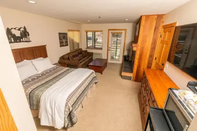 a bedroom with a bed and a living room at The Meadows - 2 Bdrm Family Condo in Kirkwood in Kirkwood
