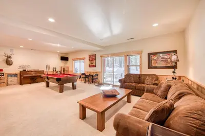 a living room with a couch and a pool table at Kindred Pines at Tahoe Donner by Tahoe Getaways - 3BR with Pool Table & HOA in Truckee