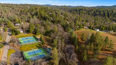 an aerial view of an estate with two tennis courts at Game Room, 8 guests- Lake, Yosemite, Sonora nearby in Groveland