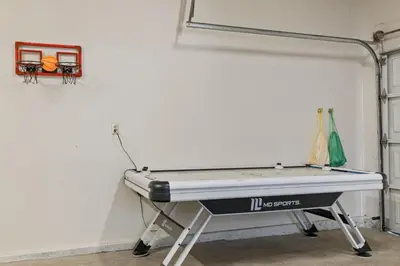 a ping pong table against a white wall at Game Room, 8 guests- Lake, Yosemite, Sonora nearby in Groveland