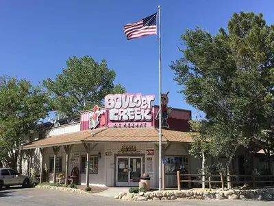 a building with an american flag on top of it at Boulder Creek RV Resort in Lone Pine
