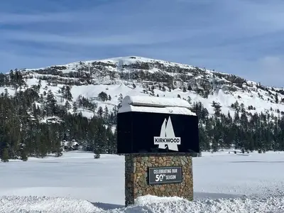 a sign in the snow in front of a mountain at Kirkwood Studio SKI IN Walk out in Kirkwood