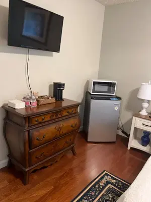 a room with a dresser with a microwave and a television at Tranquil 1BR Haven Peaceful Stay in Prime Clovis in Clovis