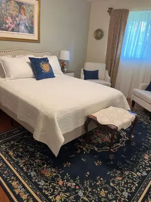 a bedroom with a large bed and a chair at Tranquil 1BR Haven Peaceful Stay in Prime Clovis in Clovis