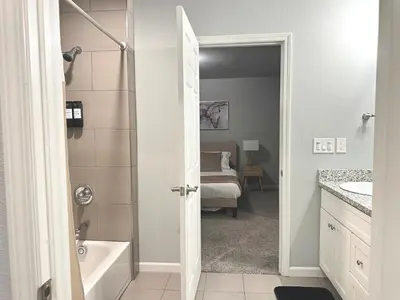 a bathroom with a tub and a sink and a toilet at Cozy 3 Bedroom Walk to UC Davis Medical Near Midtown in Sacramento