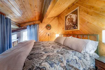 a bedroom with a bed in a wooden room at Tramway Loft Cozy Stay for 4 in Stateline