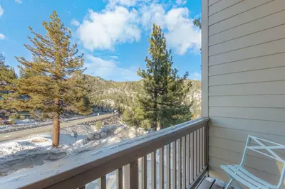 a balcony with a view of the snow covered trees at Tramway Loft Cozy Stay for 4 in Stateline