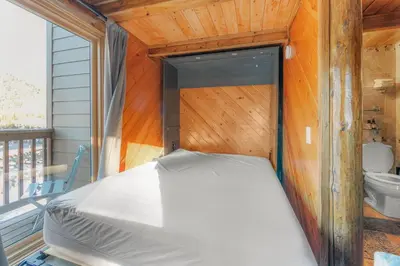 a bed in a room with a toilet on a balcony at Tramway Loft Cozy Stay for 4 in Stateline
