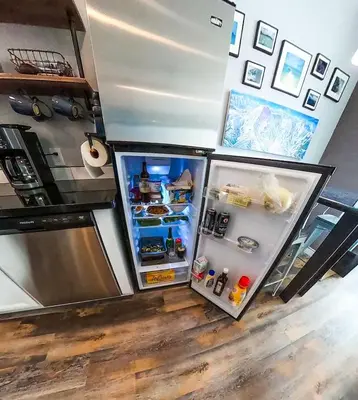 a refrigerator with its door open in a kitchen at Ski in or Walk to lifts hot tub covered parking in Kirkwood