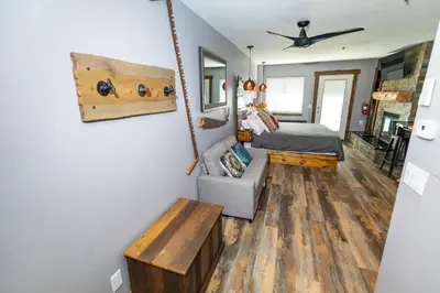 a bedroom with a bed and a couch in a room at Walk to the lifts hot tub covered parking luxury in Kirkwood