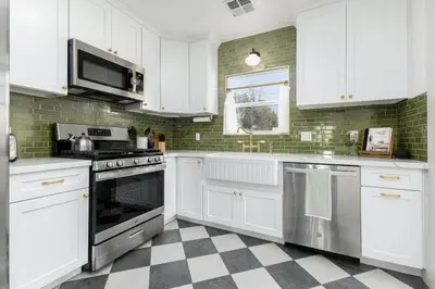 a kitchen with white appliances and a checkered floor at 2 bed1 bath, historic beauty, walk downtown in Visalia