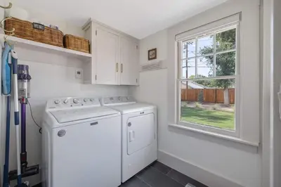 a kitchen with a washer and dryer and a window at 2 bed, 2 bath, historic beauty, walk downtown in Visalia