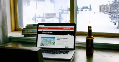 a bottle of beer and a laptop and a bottle of wine at Ski in out King bed Suite Mountain View in Kirkwood