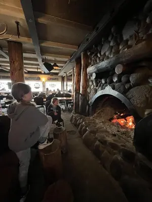 a person standing in front of a brick oven at Ski in Ski out King Bed Suite Hotel Room Near Village in Kirkwood