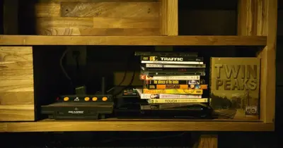 a shelf with a stack of dvds and other books at Ski in Ski out Dream Studio Village Mtn Views in Kirkwood