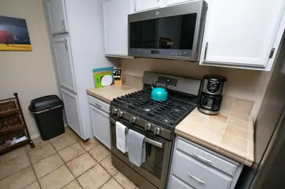 a kitchen with a stove and a microwave at Ski in Ski out Dream Studio Village Mtn Views in Kirkwood