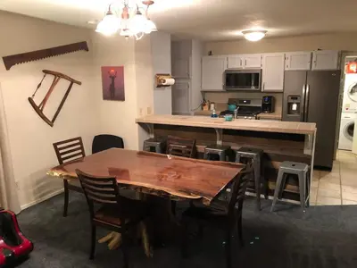 a kitchen with a wooden table and chairs and a counter at True Ski in out Large 2 bdrm Mtn Views 4 beds in Kirkwood