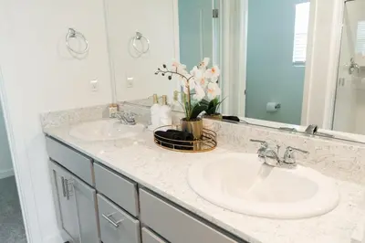 a bathroom with two sinks and a mirror at Beautiful Modern Home with Outdoor Patio and BBQ Grill in Elk Grove