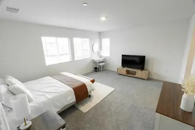 a bedroom with a bed and a flat screen tv at Beautiful Modern Home with Outdoor Patio and BBQ Grill in Elk Grove