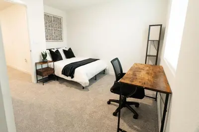 a bedroom with a bed and a desk and a table at Beautiful Modern Home with Outdoor Patio and BBQ Grill in Elk Grove