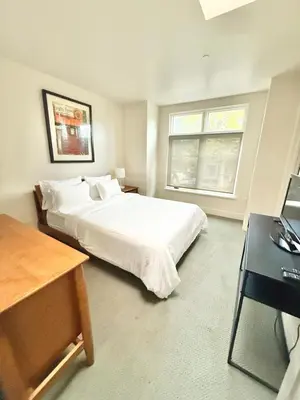 a bedroom with a white bed and a window at Modern 2 Bedroom by Midtown Walk Distance to Bars and Restaurants in Sacramento