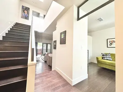 a staircase in a house with a green couch at Modern 2 Bedroom by Midtown Walk Distance to Bars and Restaurants in Sacramento