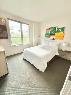 a bedroom with a large white bed with a window at Modern 2 Bedroom by Midtown Walk Distance to Bars and Restaurants in Sacramento