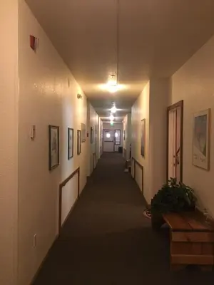 a hallway in a building with paintings on the walls at Sun Meadows Cozy Kirkwood Ski In out Studio in Kirkwood