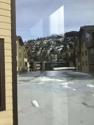 a view of a parking lot with snow and buildings at Sun Meadows Cozy Kirkwood Ski In out Studio in Kirkwood