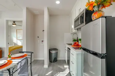 a kitchen with a refrigerator and a table at Great for Digital Nomads! Convenient Manteca Apt in Manteca