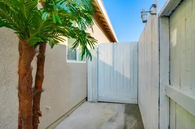 a palm tree next to a fence with a gate at Great for Digital Nomads! Convenient Manteca Apt in Manteca