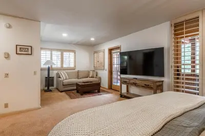 a bedroom with a bed and a tv and a couch at Bridges 3 in Mammoth Lakes