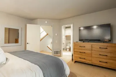 a bedroom with a bed and a flat screen tv at Bridges 3 in Mammoth Lakes
