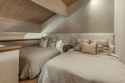two beds sitting next to each other in a room at Bridges 3 in Mammoth Lakes