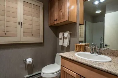 a bathroom with a white toilet and a sink at Bridges 3 in Mammoth Lakes