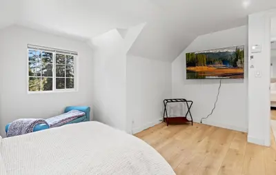 a white bedroom with a bed and two windows at Luxury Cabin in Budget-Hot Tub -Apple Hills-Tahoe in Pollock Pines