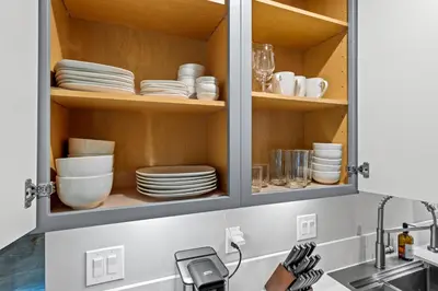 a kitchen cabinet with plates and dishes in it at Luxury Cabin in Budget-Hot Tub -Apple Hills-Tahoe in Pollock Pines