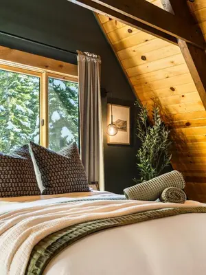 a bedroom with a bed and a large window at Starlight Chalet Lake Tahoe in Carnelian Bay