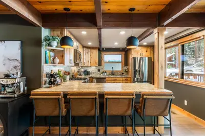 a kitchen with a large island with bar stools at Starlight Chalet Lake Tahoe in Carnelian Bay