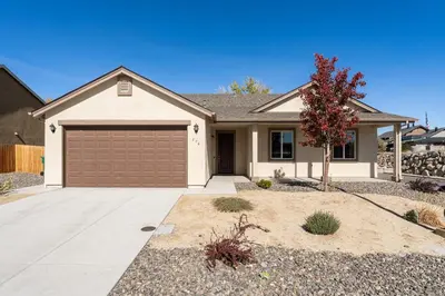 a house with a garage and a tree at Dusty Sage Hollow in Fernley
