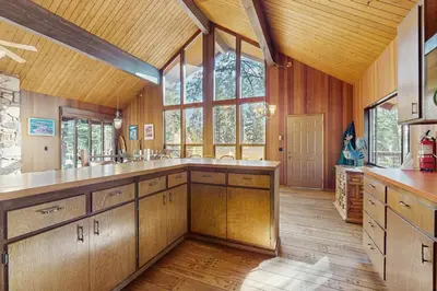 a large kitchen with wooden cabinets and a large window at Alpenglow at Dollar Point in Dollar Point