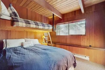 a bedroom with a bed in a wooden wall at Alpenglow at Dollar Point in Dollar Point