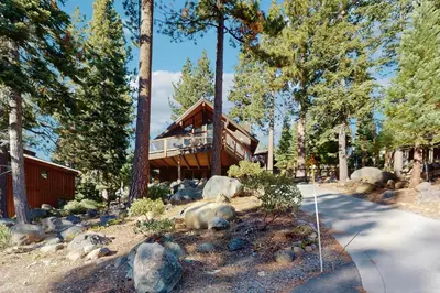 a bear laying on the ground in front of a house at Alpenglow at Dollar Point in Dollar Point