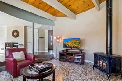 a living room with a wood stove and a couch at 2253 Catalina Drive home in South Lake Tahoe