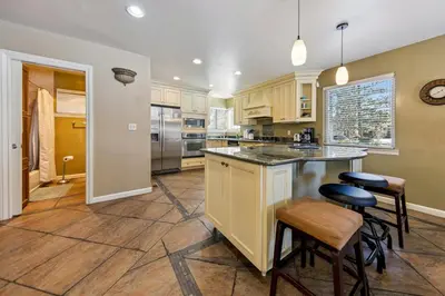 a kitchen with a large island with stools at 2253 Catalina Drive home in South Lake Tahoe