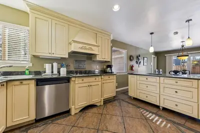 a kitchen with white cabinets and stainless steel appliances at 2253 Catalina Drive home in South Lake Tahoe